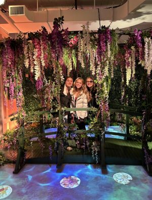 From left to right, BRHS students Camryn Allen, Emma Hamlett, and Gianna Jakubowski walk over a bridge of water lilies at the Monet Exhibition. 