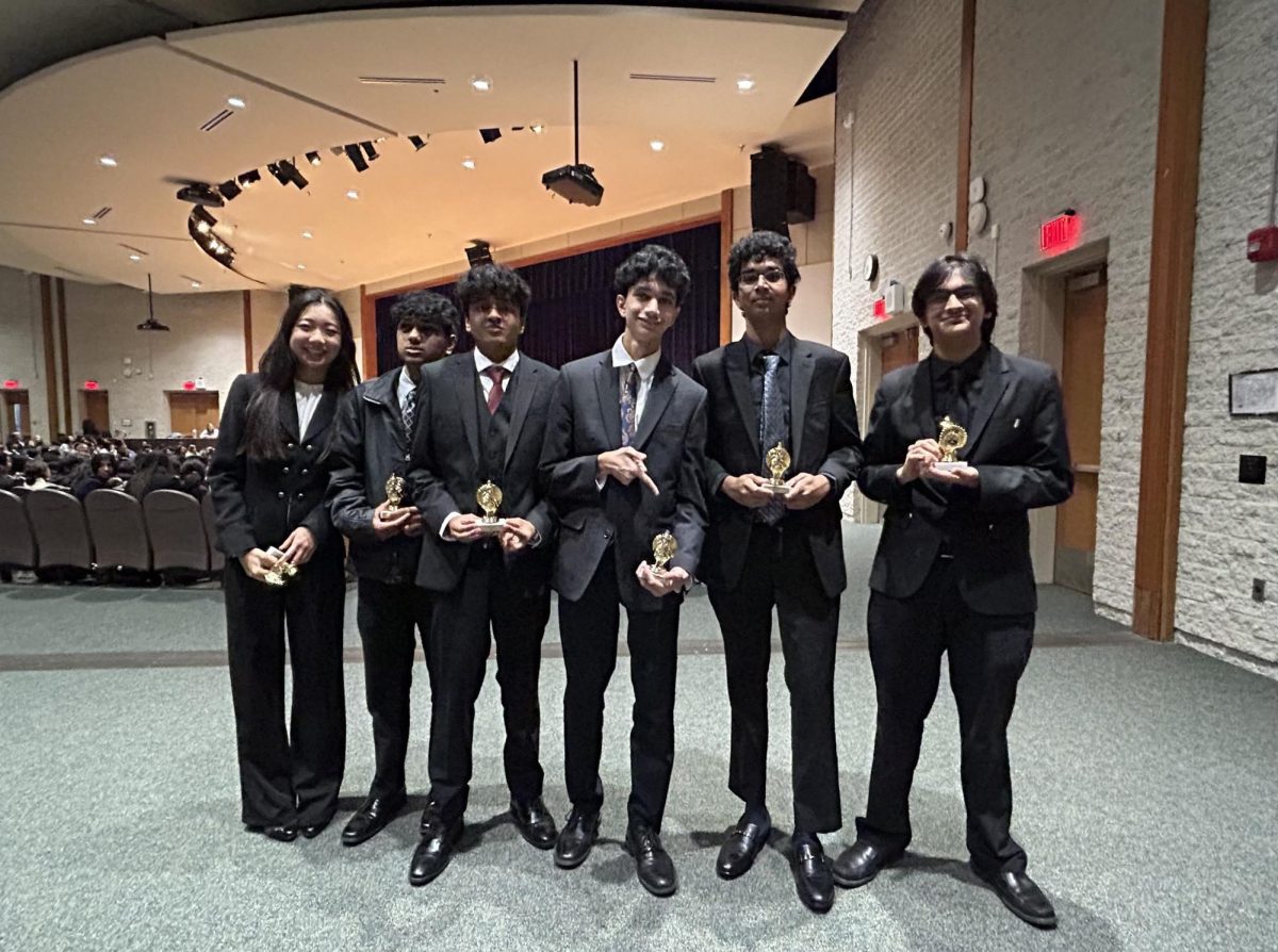 The BRHS team winners in the Junior Varsity Public Forum category strike a pose with their trophies.