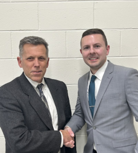 New Assistant Principal Mr. Leaman shakes Superintendent Beers' hand.