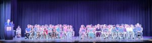 Principal Hemberger makes a speech at the Senior Awards Ceremony while the seniors await the results. 
