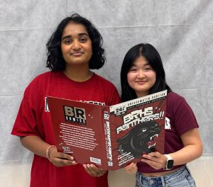 Co-editors Rhea Muppane and Gracelynne Hao, respectively, show off their award winning yearbook.
