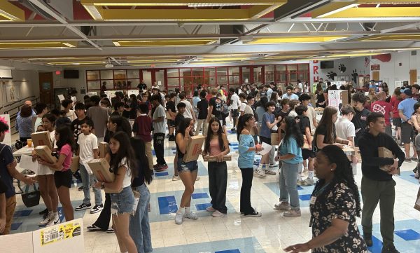 Freshmen attend club fair in the large cafeteria.