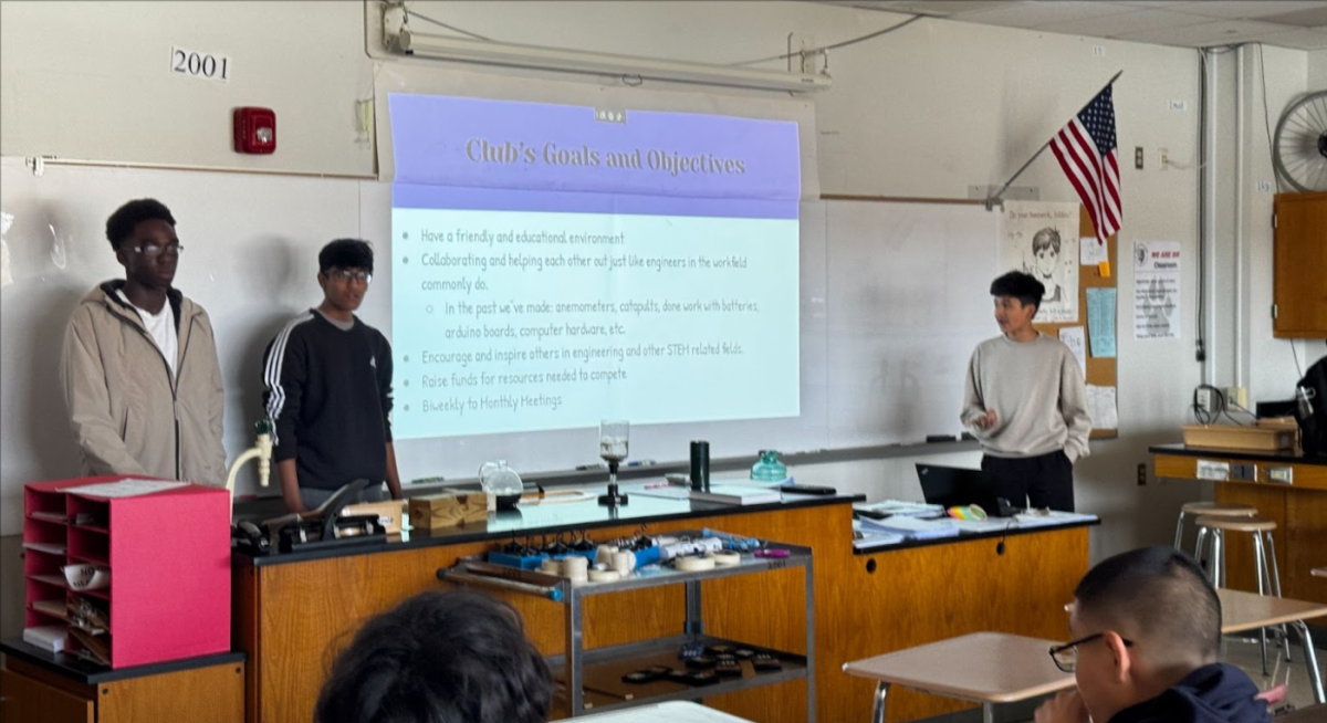 Officers Giovanni Anyanwu, Shaurya Jain, and Anvay Ajmera, from left to right, presenting the club’s goals and objectives.