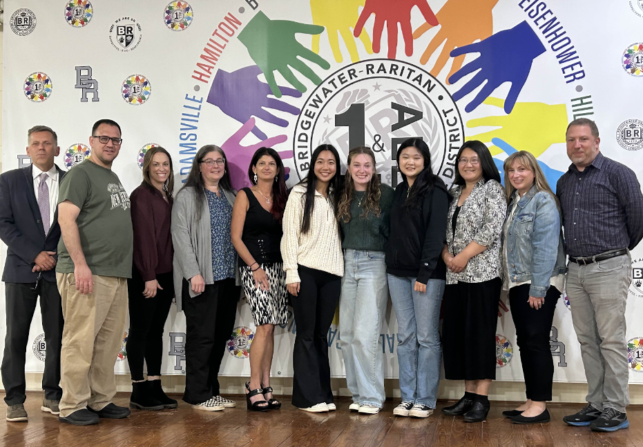 Sunny Chen, Gianna Callari and Isabel Lu (center, from left to right) were in attendance at a board session alongside other Board of Ed members.